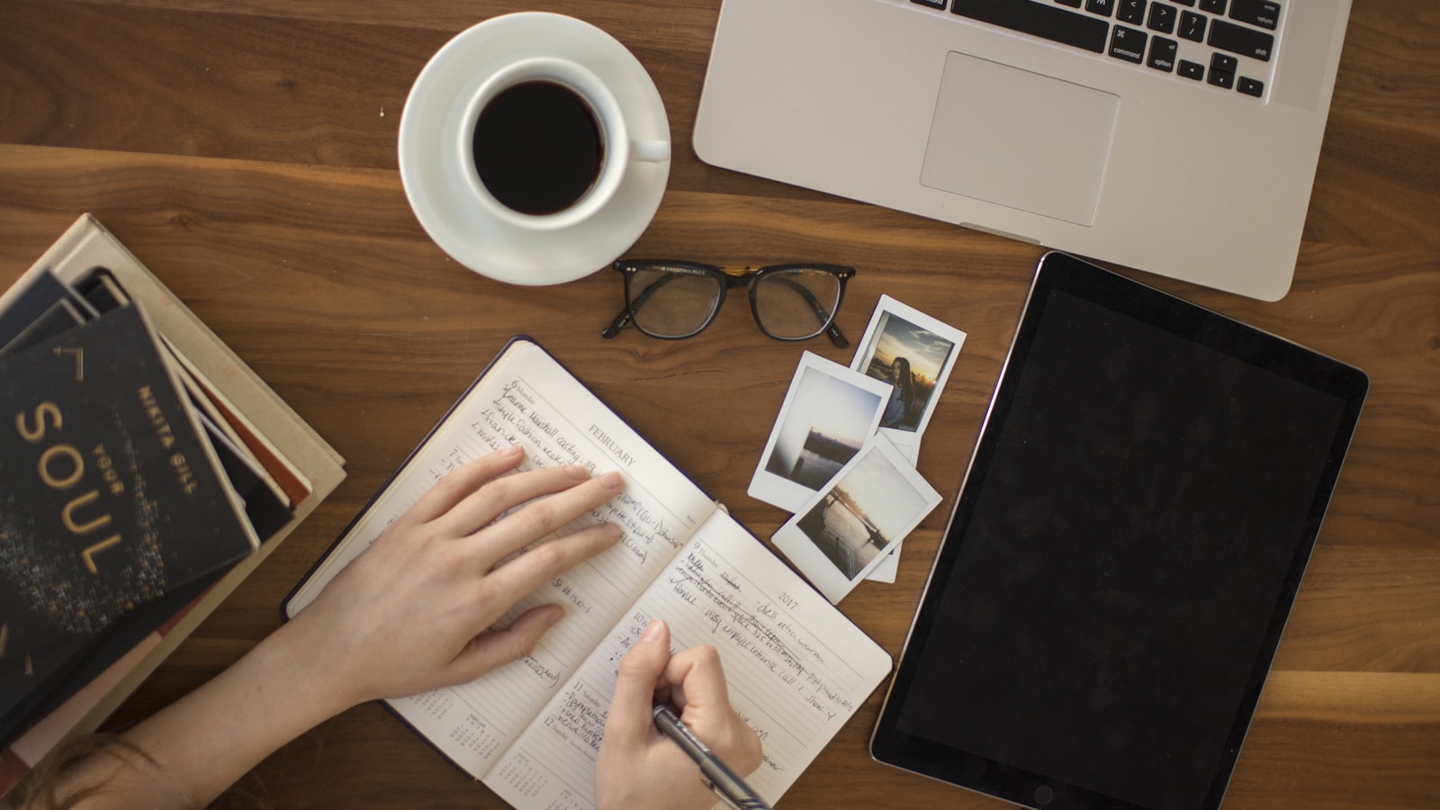 A laptop and notebook on a desk